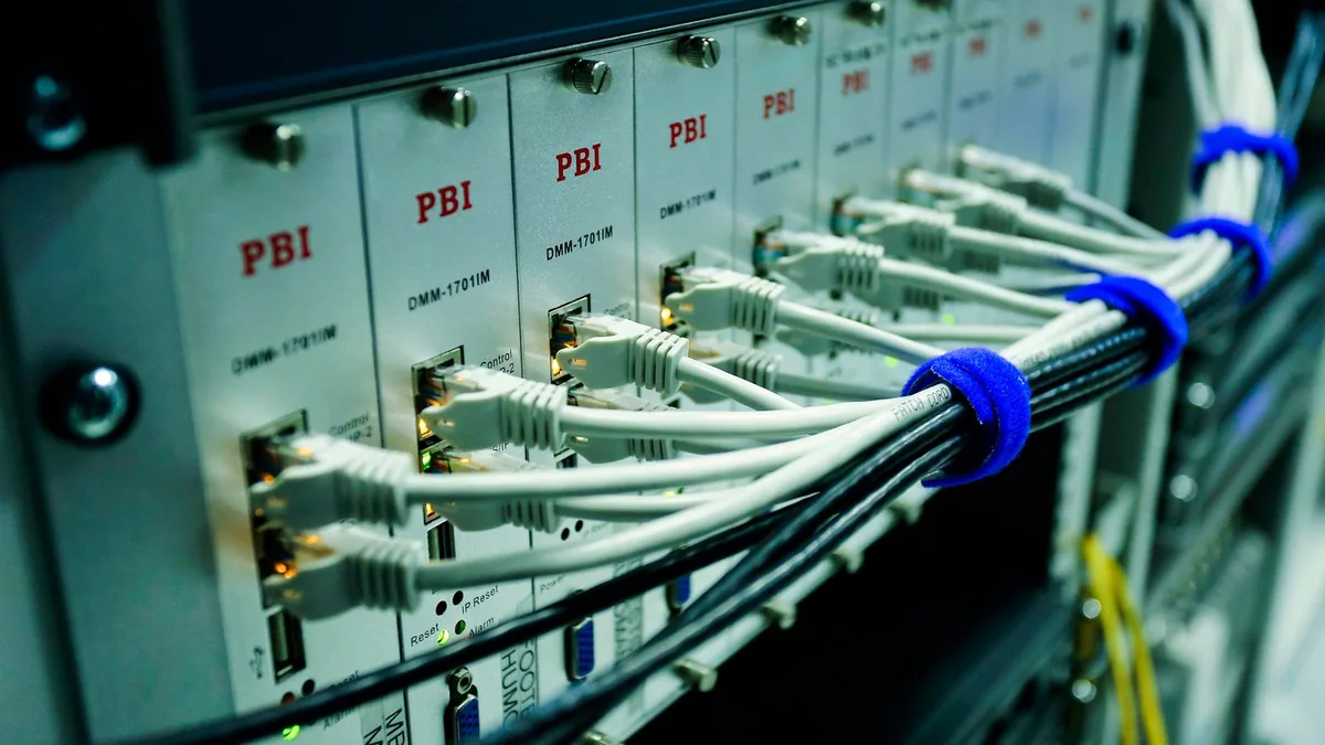infogérance : câbles réseau branchés sur un switch informatique