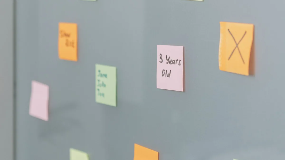 Métier consultant SEO : notes autocollantes d'un plan d'action collées sur une paroi vitrée